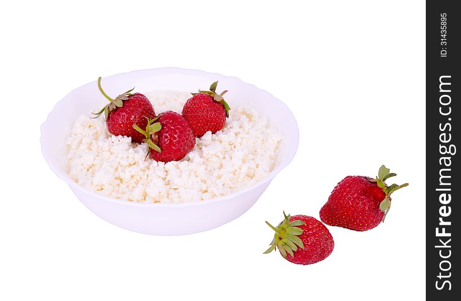 The plate with cottage cheese and strawberries isolated on white. The plate with cottage cheese and strawberries isolated on white.