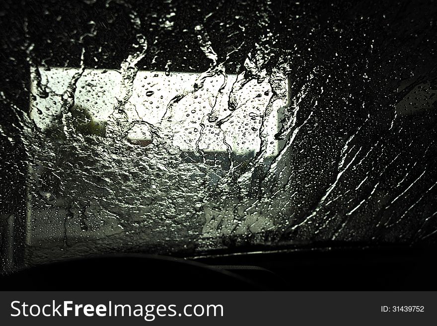 Water pattern of a car front window at the end of the carwash cycle. Water pattern of a car front window at the end of the carwash cycle.