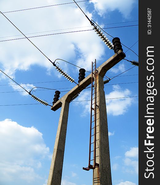 Triple concrete portal electricity pylon located next to a small rural sub station. Triple concrete portal electricity pylon located next to a small rural sub station