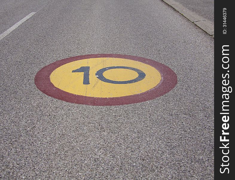 Speed limit sign painted on asphalt