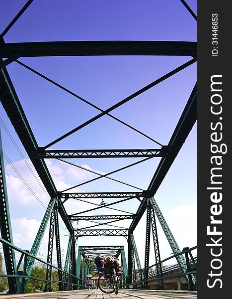 Bicycle On Historical Iron Bridge, Cloudy And Blue Sky