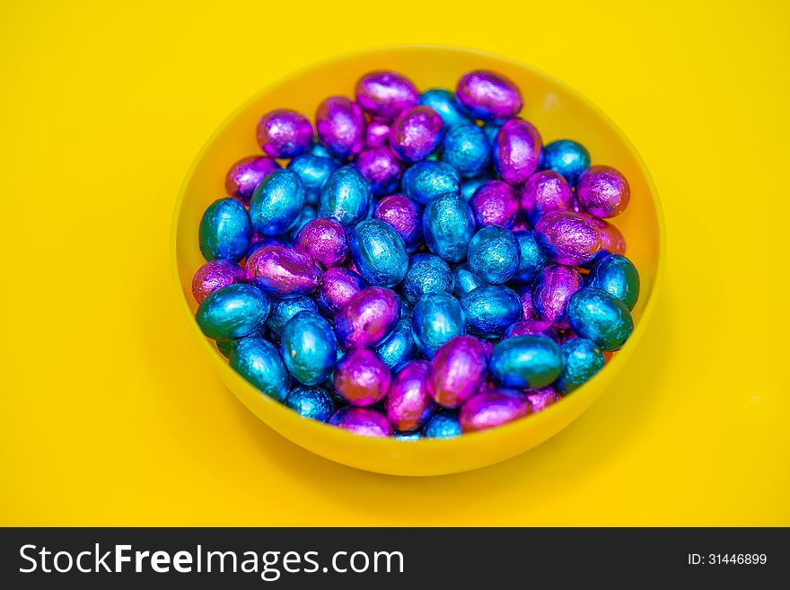 Colorful candy closeup on yellow background