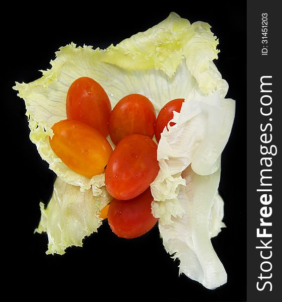 Cabbage leaf with ripe tomatoes