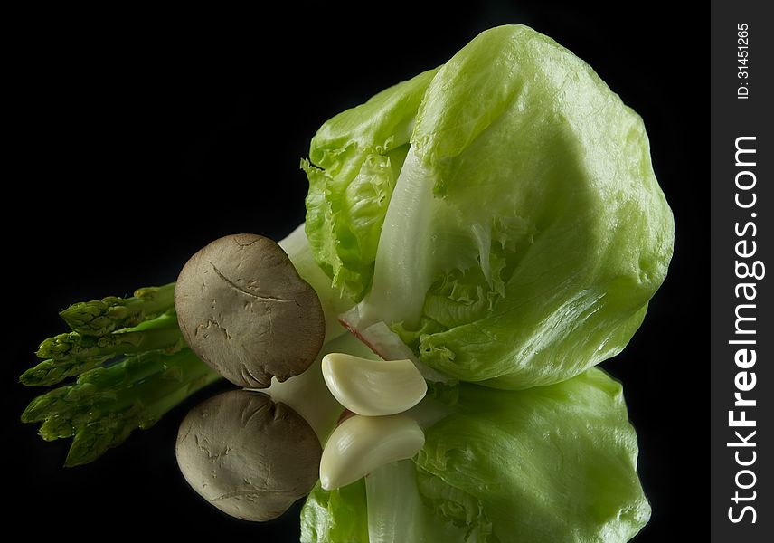 Ð¡abbage, mushrooms, garlic and asparagus isolated on black
