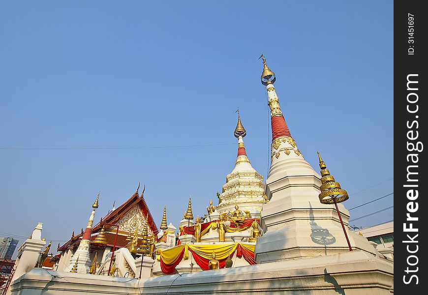 Chapel and white pagoda with gold decoration at wat songtham, Phra Pradaeng, Samut Prakan province, Thailand. Chapel and white pagoda with gold decoration at wat songtham, Phra Pradaeng, Samut Prakan province, Thailand