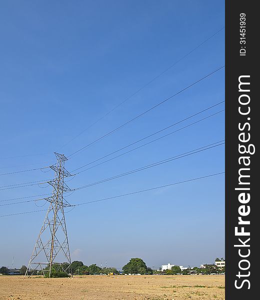 High voltage tower and cable line cross is terrain in blue sky. High voltage tower and cable line cross is terrain in blue sky