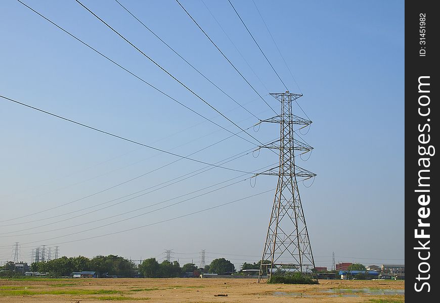 High voltage tower and grid line in plain terrain. High voltage tower and grid line in plain terrain