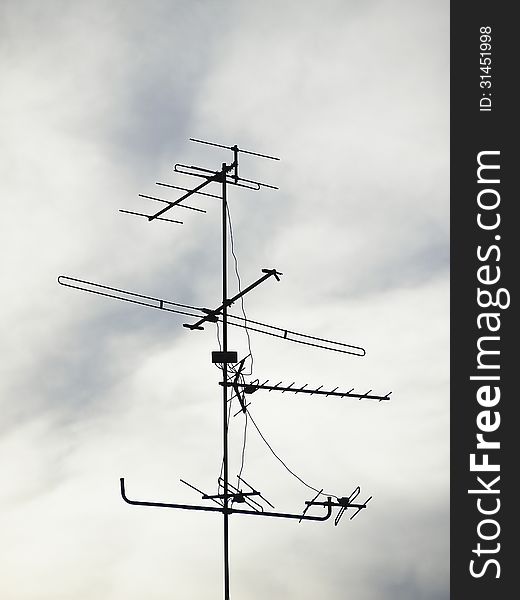 Silhouette image of antenna in cloudy sky background. Silhouette image of antenna in cloudy sky background