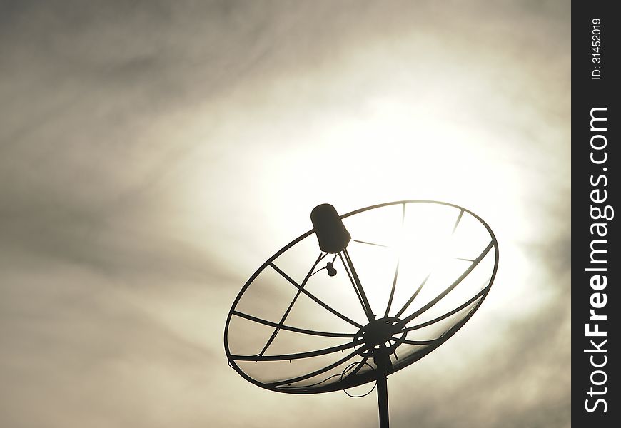 Silhouette image of satellite dish in cloudy sky. Silhouette image of satellite dish in cloudy sky