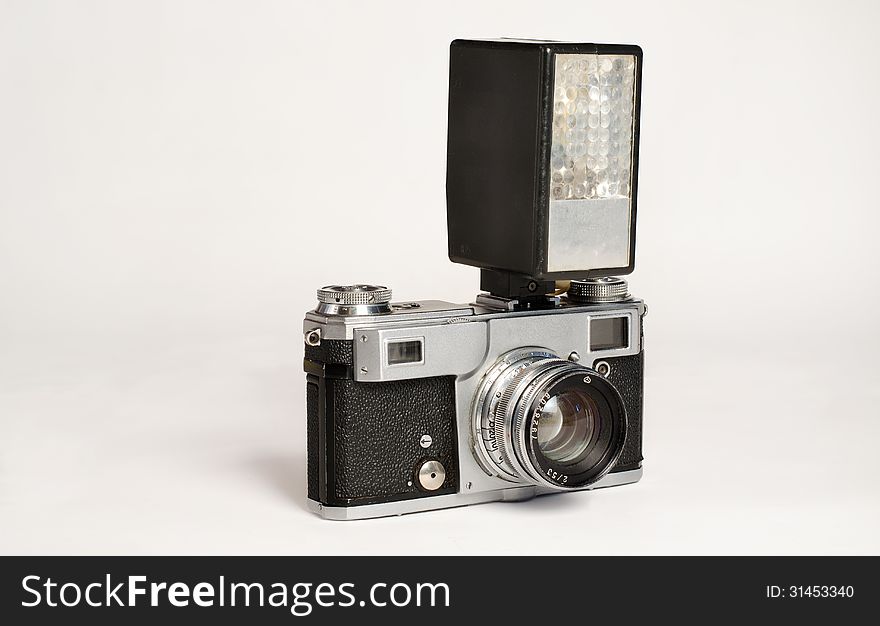 Old scratched flash camera on a white background. Old scratched flash camera on a white background