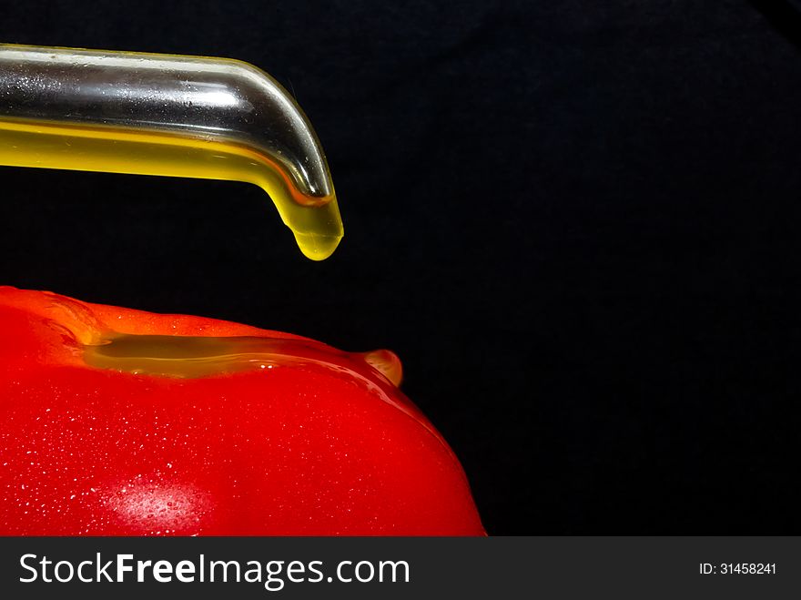 A tomato with olive oil. A tomato with olive oil