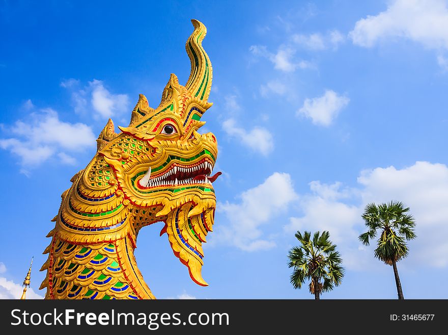 Golden Giant Snake Sculpture, North East of Thailand.(Generally in Thailand, any kind of art decoration in temples, churchs, pavilions etc. created with donated money. They are all public property or treasure, no restrict in copy or use. This photo is taken under this condition.)