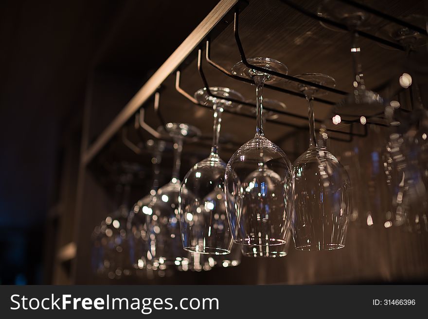 Glasses hanging over a bar rack