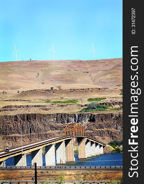 Looking north into Washington from Oregon is the Maryhill Bridge that crosses the Columbia River. Hills of Washington in the background. Tall to allow for barges and river traffic. Copy space. Looking north into Washington from Oregon is the Maryhill Bridge that crosses the Columbia River. Hills of Washington in the background. Tall to allow for barges and river traffic. Copy space