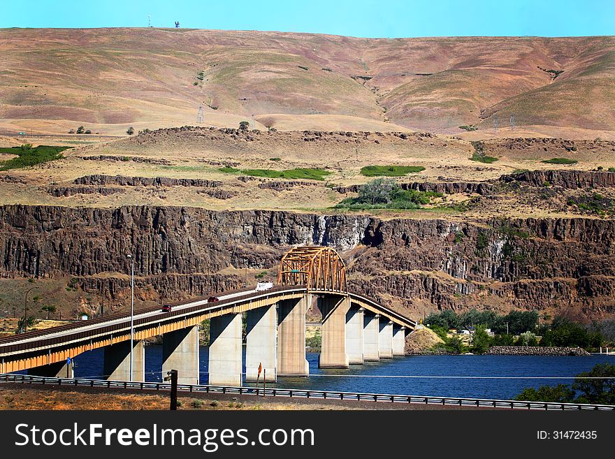 Looking north into Washington from Oregon is the Maryhill Bridge that crosses the Columbia River. Hills of Washington in the background. Tall to allow for barges and river traffic. Copy space
