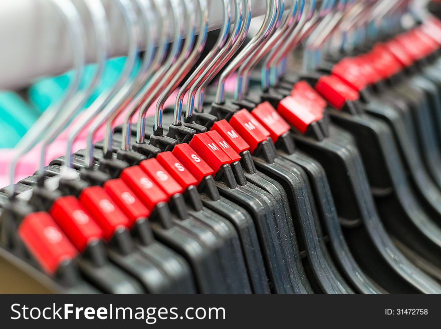 Group of cloth hanger with red sizing label in angle