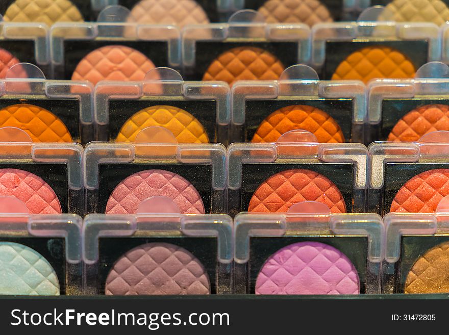 Various color of face make-up powder display in closeup row