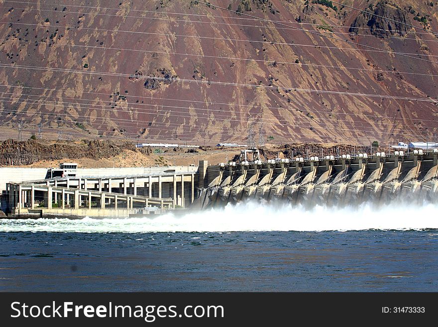 The John Day Dam view from visitor's parking lot, on the Columbia River with electical power lines overhead. The John Day Dam view from visitor's parking lot, on the Columbia River with electical power lines overhead.