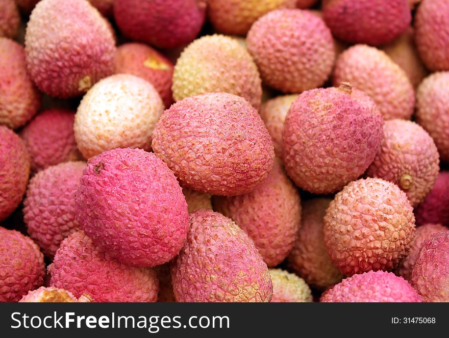 Pink freshly cut fruits lychee as an agricultural background