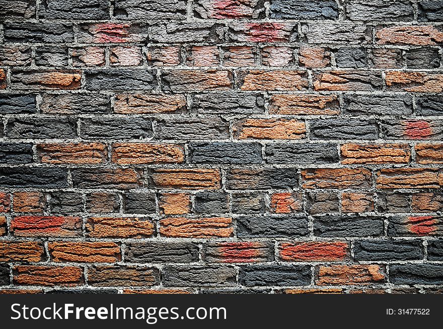 Orange and dark grey fired bricks set in thick grey mortar. House in the Annex, Toronto. Orange and dark grey fired bricks set in thick grey mortar. House in the Annex, Toronto.