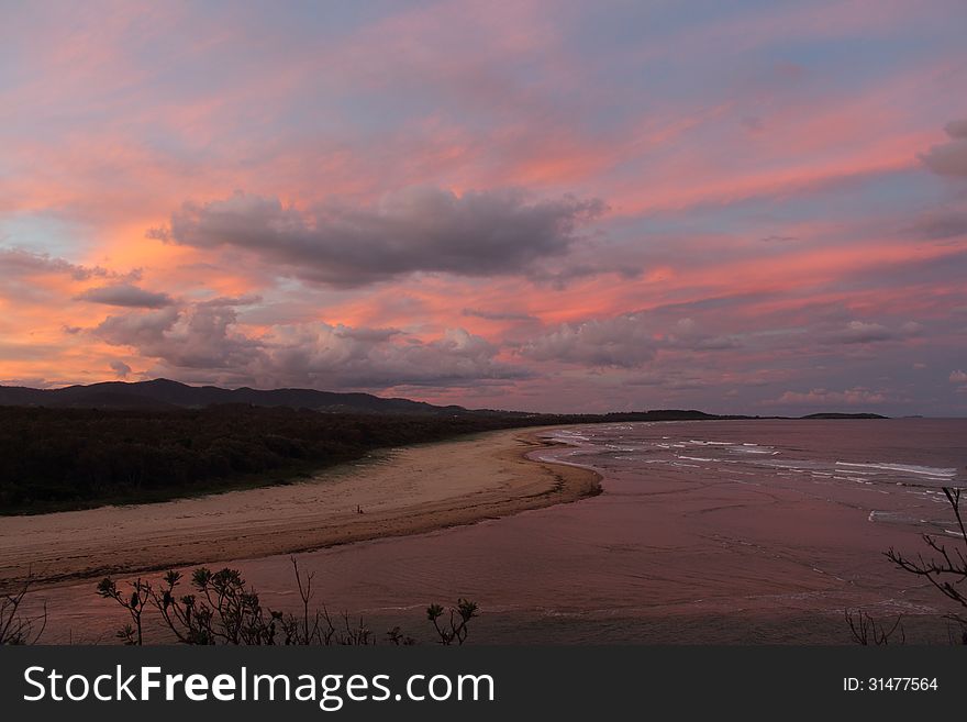 The pink sky of sunset where Boambee Creek meets the Pacific Ocean near Coffs Harbour, NSW. The pink sky of sunset where Boambee Creek meets the Pacific Ocean near Coffs Harbour, NSW
