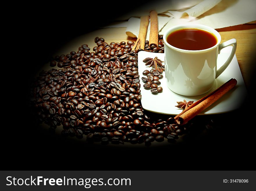 Hot coffee with beans on the table