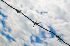 Barbed Wires Against Cloudy Sky Stock Photo Barbed Wires Against Cloudy Sky Stock Photo