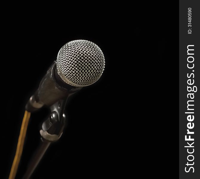 Grey iron microphone on black background