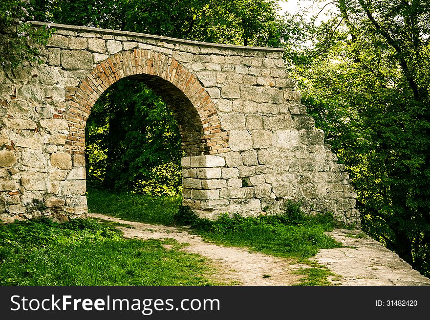 An ancient stone arch in the forest