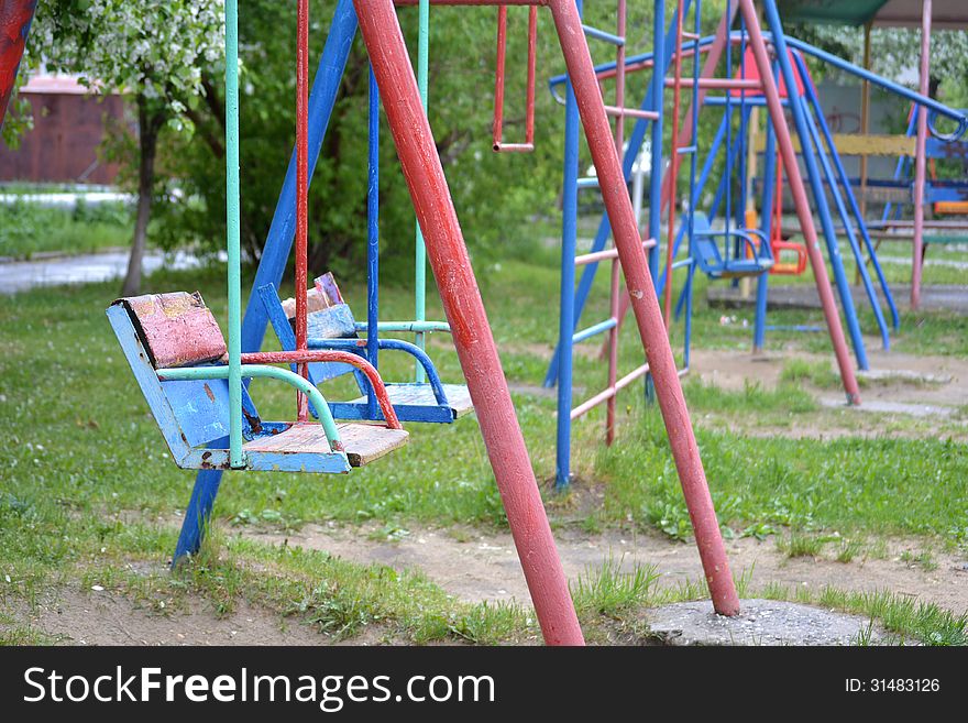 Empty children's swing in a yard. Empty children's swing in a yard