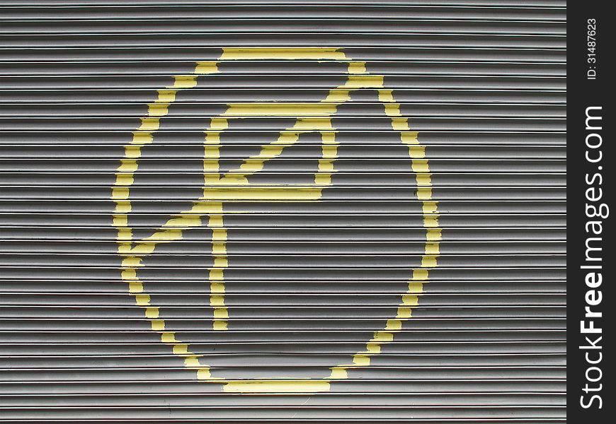 Hand painted no parking sign on gray roll up gates