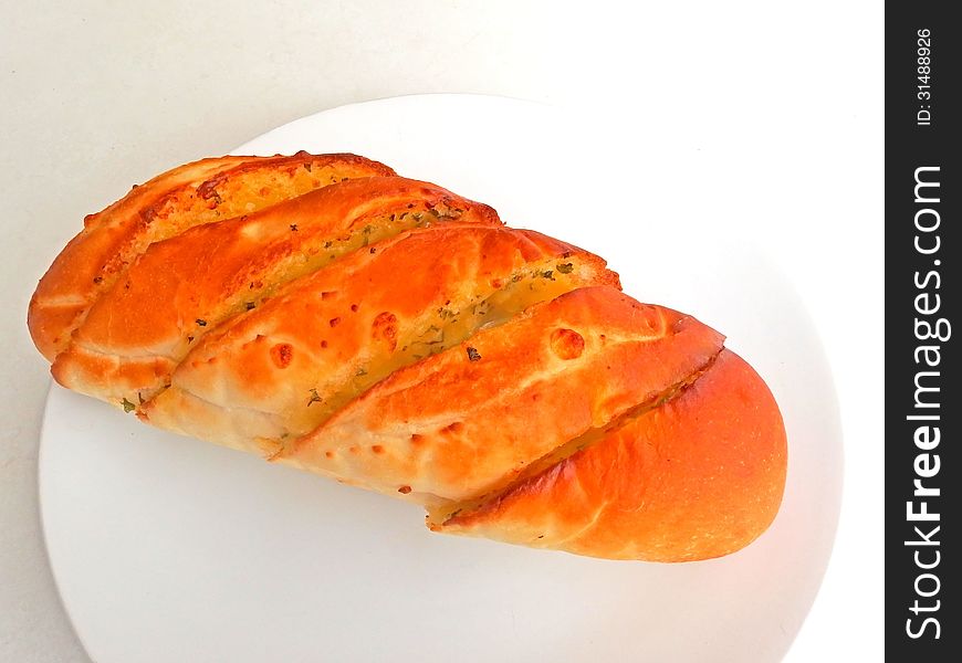 Close up of garlic bread on white dish