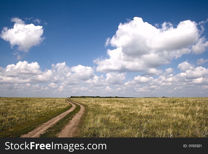 Rural landscape with road and clouds