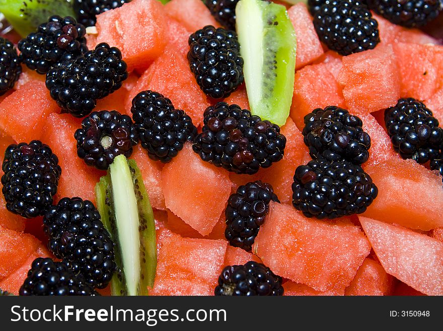 Detail of fruit salad with watermelon, kiwi and blackberry