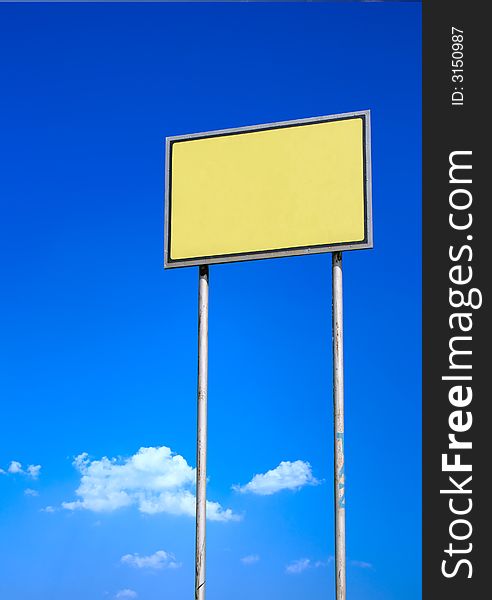 Blank yellow sign against deep blue sky. Blank yellow sign against deep blue sky