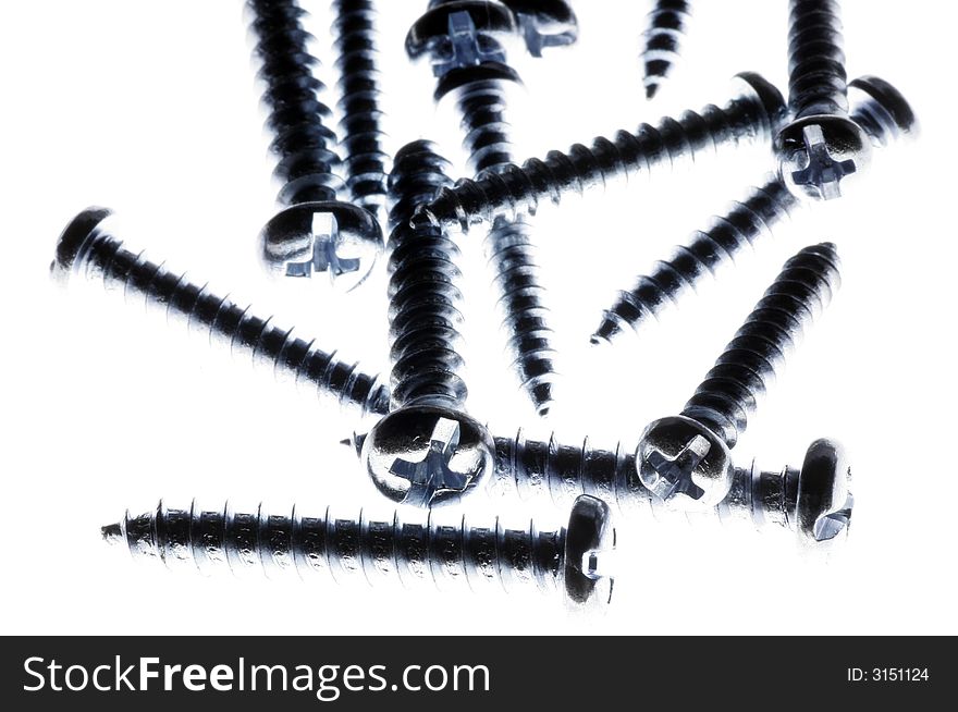 Macro Close-Up Of Spiral Metal Screws On A White Background