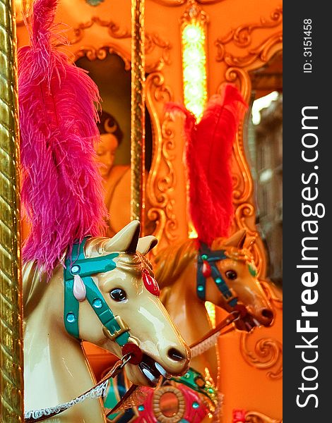 A closeup of two horses on a merry-go-round