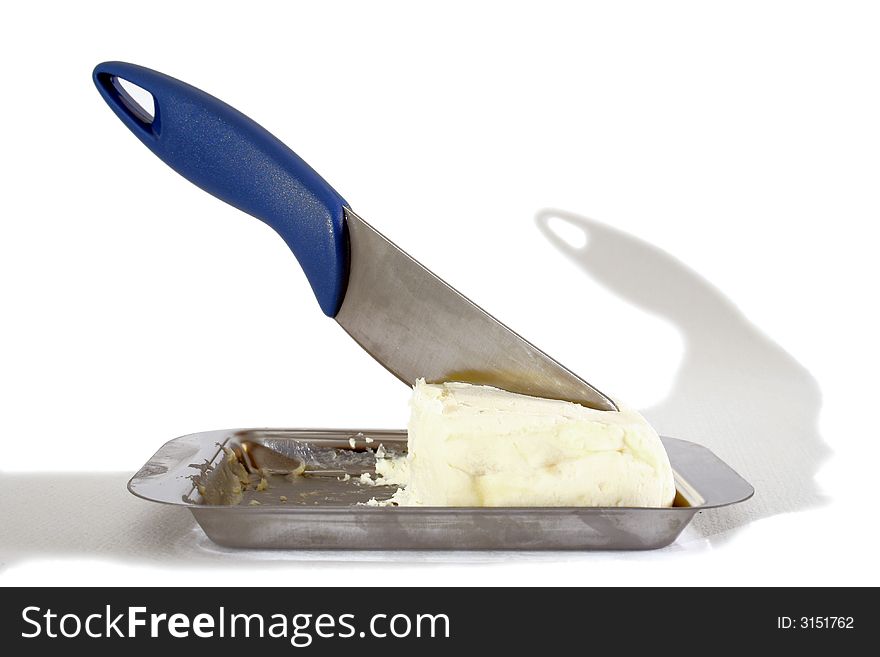 Knife cutting a slice of butter. Knife cutting a slice of butter
