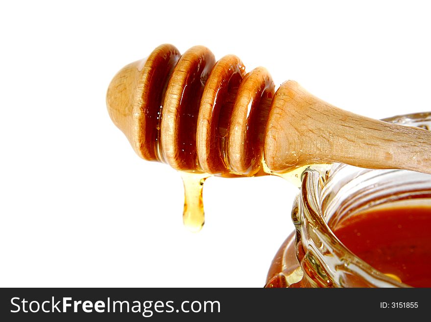 Sweet honey dropping from a jar. Sweet honey dropping from a jar