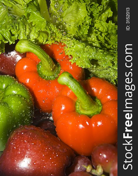 Close up of fruits and vegetables under the stream of water. Close up of fruits and vegetables under the stream of water