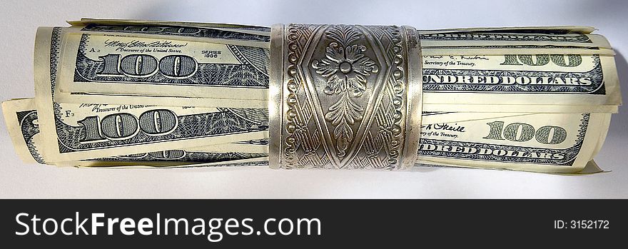 US dollars in a silver napkin ring
