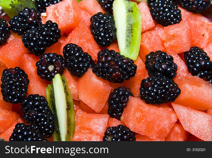 Detail of fruit salad with watermelon, kiwi and blackberry