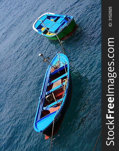 Fishing blue painted boats on a calm sea tropical water at the Canary Islands. Fishing blue painted boats on a calm sea tropical water at the Canary Islands