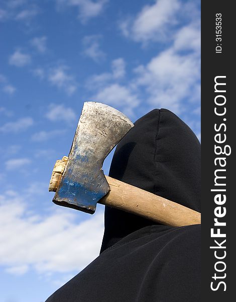 Man with an axe on sky background