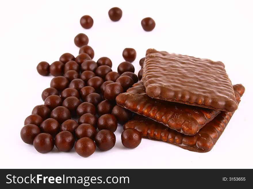 Black and brown chocolate sweets against white background