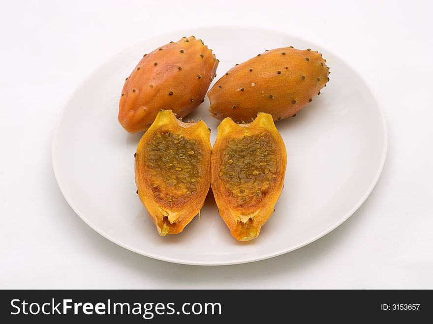 Prickly pears, aslo known as Indian fig, Barbery fig or Tuna fig on a white plate. Prickly pears, aslo known as Indian fig, Barbery fig or Tuna fig on a white plate