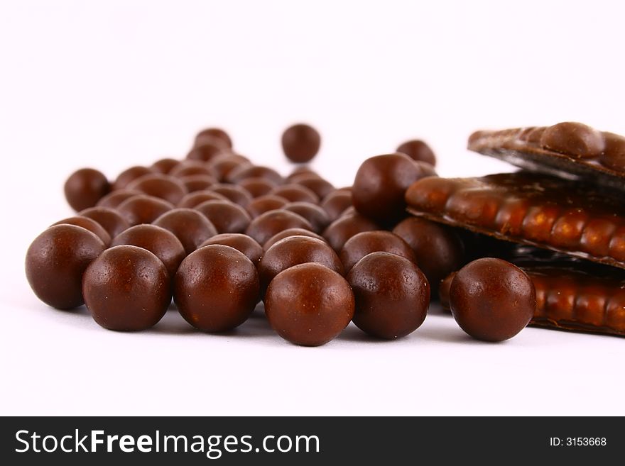 Black and brown chocolate sweets against white background