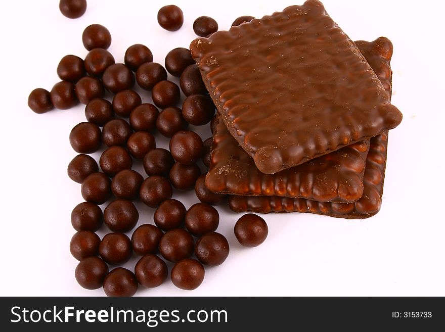 Black and brown chocolate sweets against white background