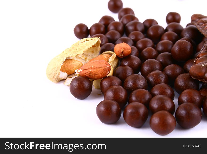 Black and brown chocolate sweets against white background