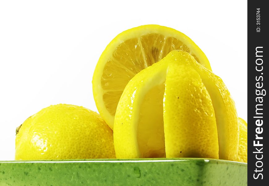 Lemon in green bowl in green bowl on white background. Lemon in green bowl in green bowl on white background